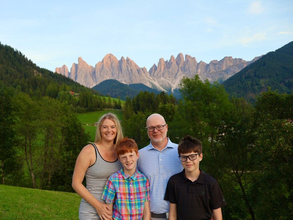 Family photo in front at the Santa Magdalen viewpoint in the Dolomites