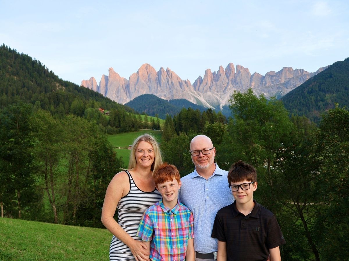Family photo in front at the Santa Magdalen viewpoint in the Dolomites